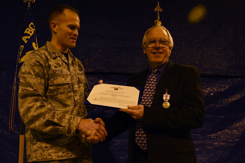 Philip Shailer an electrician with the 423rd Civil Engineer Squadron, RAF Alconbury, United Kingdom, receives the Outstanding civilian Career Service Award at his retirement ceremony, February 26, 2016, at RAF Alconbury. Shailer began his career on RAF Alconbury as a teenaged apprentice electrician, and worked on the base for the next 47 years.