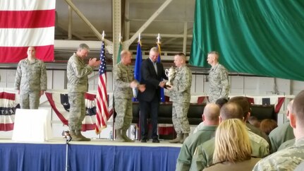 U.S. Air Force Lt. Gen. Stephen W. Wilson (third from left), U.S. Strategic Command (USSTRATCOM) deputy commander, and Mr. W. Gary Gates (third from right), Strategic Command Consultation (SCC) Committee member, present the 2015 Omaha Trophy, strategic aircraft category, to U.S. Air Force Col. Brian McDaniel (second from right), 92nd Air Refueling Wing commander, during an award ceremony at Fairchild Air Force Base, Wash., March 14, 2016. Wilson and Gates presented the trophy, on behalf of USSTRATCOM and the SCC, to recognize the 92nd Air Refueling Wingâ€™s contributions to USSTRATCOMâ€™s global strategic missions. The Omaha Trophy, which dates back to the U.S. Air Forceâ€™s Strategic Air Command, was originally created by the SCC in 1971. At the time, a single trophy was presented annually as a token of appreciation to USSTRATCOMâ€™s best wing. Since then, the tradition has evolved to unit-level awards that recognize the commandâ€™s premier intercontinental ballistic missile (ICBM) wing, ballistic missile submarine, strategic bomber wing and global operations (space/cyberspace) unit. This year, a new category was added to include the combatant commandâ€™s top strategic aircraft wing. (USSTRATCOM photo by Dave Wells)  Story Available : https://www.stratcom.mil/news/2016/595/-/
