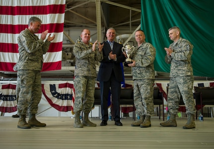 U.S. Air Force Lt. Gen. Stephen W. Wilson (second from left), U.S. Strategic Command (USSTRATCOM) deputy commander, and Mr. W. Gary Gates (center), Strategic Command Consultation (SCC) Committee member, present the 2015 Omaha Trophy, strategic aircraft category, to U.S. Air Force Col. Brian McDaniel (second from right), 92nd Air Refueling Wing commander, and other base leaders during an award ceremony at Fairchild Air Force Base, Wash., March 14, 2016. Also pictured on stage are U.S. Air Force Lt. Gen. Samuel D. Cox (left), 18th Air Force and USSTRATCOMâ€™s Task Force 294 commander, and U.S. Air Force Chief Master Sgt. Christian M. Pugh (right), 92nd Air Refueling Wing command chief master sergeant. Wilson and Gates presented the trophy, on behalf of USSTRATCOM and the SCC, to recognize the 92nd Air Refueling Wingâ€™s contributions to USSTRATCOMâ€™s global strategic missions. The Omaha Trophy, which dates back to the U.S. Air Forceâ€™s Strategic Air Command, was originally created by the SCC in 1971. At the time, a single trophy was presented annually as a token of appreciation to USSTRATCOMâ€™s best wing. Since then, the tradition has evolved to unit-level awards that recognize the commandâ€™s premier intercontinental ballistic missile (ICBM) wing, ballistic missile submarine, strategic bomber wing and global operations (space/cyberspace) unit. This year, a new category was added to include the combatant commandâ€™s top strategic aircraft wing. (U.S. Air Force photo by Airman 1st Class Sean Campbell)