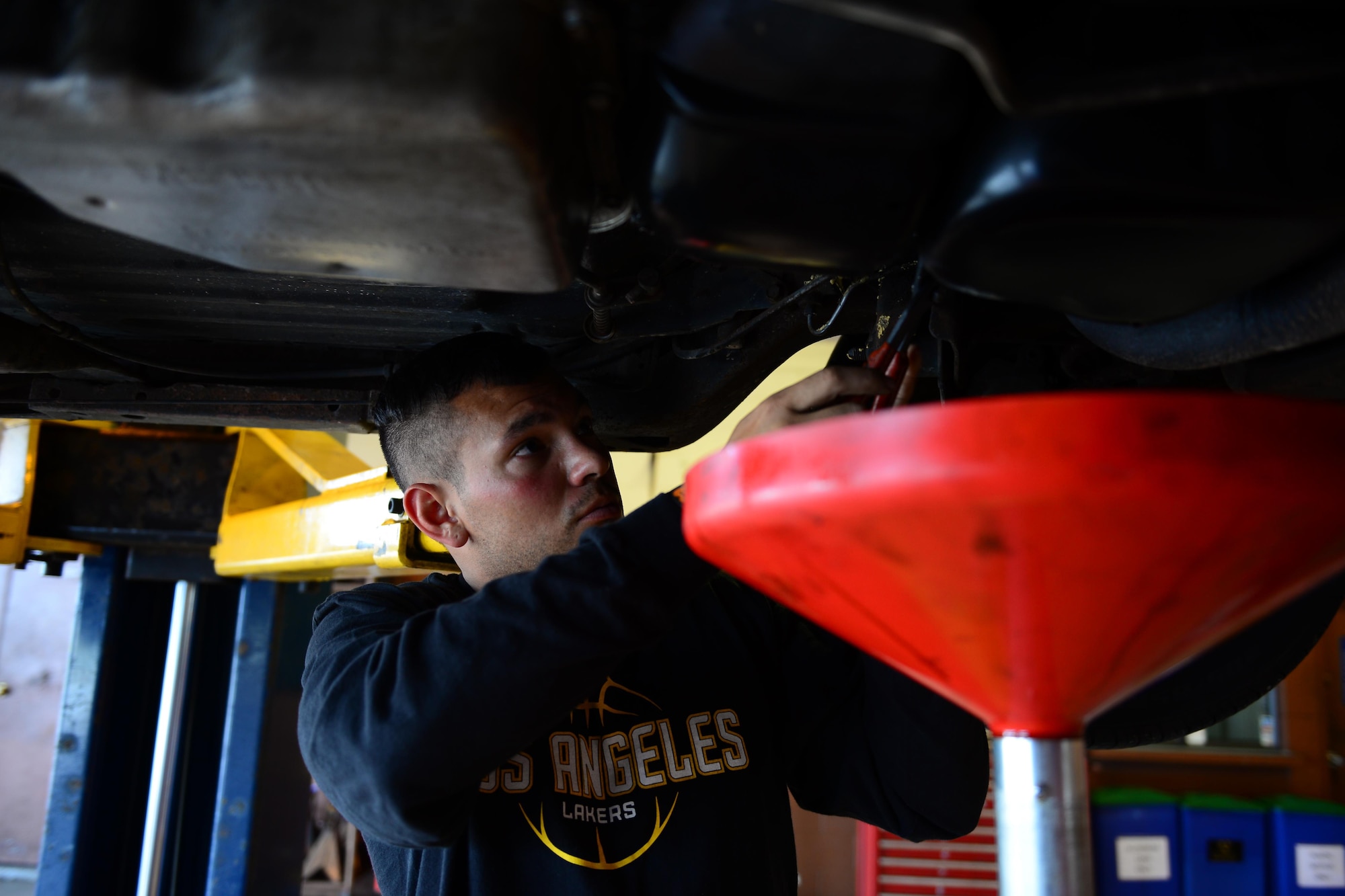 Airman 1st Class Chris Avila, 36th Logistics Readiness Squadron fuels distribution operator, removes an oil filter from his vehicle March 5, 2016, at the Auto Hobby Shop on Andersen Air Force Base, Guam. The shop offers classes that teach customers to align their vehicle, change oil, run diagnostic scans, replace brakes and repair tires. (U.S. Air Force photo/Airman 1st Class Jacob Skovo)