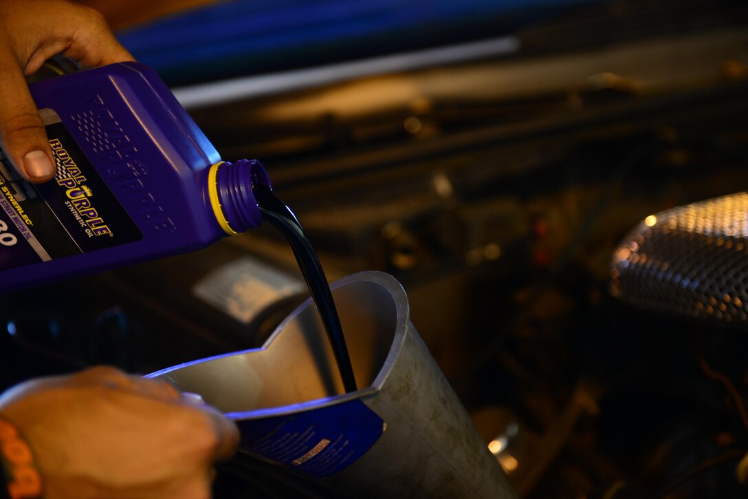 Airman 1st Class Chris Avila, 36th Logistics Readiness Squadron fuels distribution operator, replaces his motor oil March 5, 2016, at the Auto Hobby Shop on Andersen Air Force Base, Guam. In addition to having a wide selection of simple and advanced tools, the shop also has the means to properly dispose of or recycle used automotive fluids used on site. (U.S. Air Force photo/Airman 1st Class Jacob Skovo)