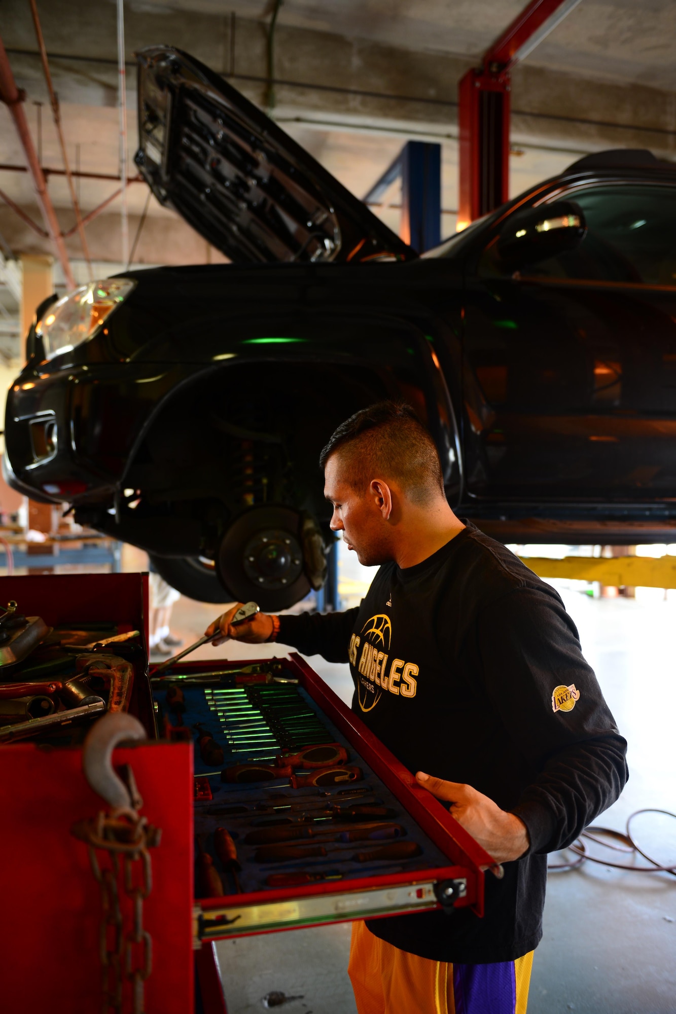 Airman 1st Class Chris Avila, 36th Logistics Readiness Squadron fuels distribution operator, returns a ratchet to its designated place March 5, 2016, at the Auto Hobby Shop on Andersen Air Force Base, Guam. Employees of the shop will walk customers through complicated repairs if needed. (U.S. Air Force photo/Airman 1st Class Jacob Skovo)