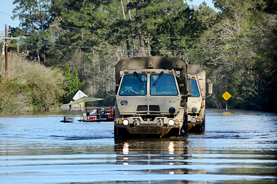 Soldiers operating M1078 tactical vehicles assist residents after they lost power to their homes just east of Ponchatoula, La., March 13, 2016. Army National Guard photo by 1st Sgt. Paul Meeker