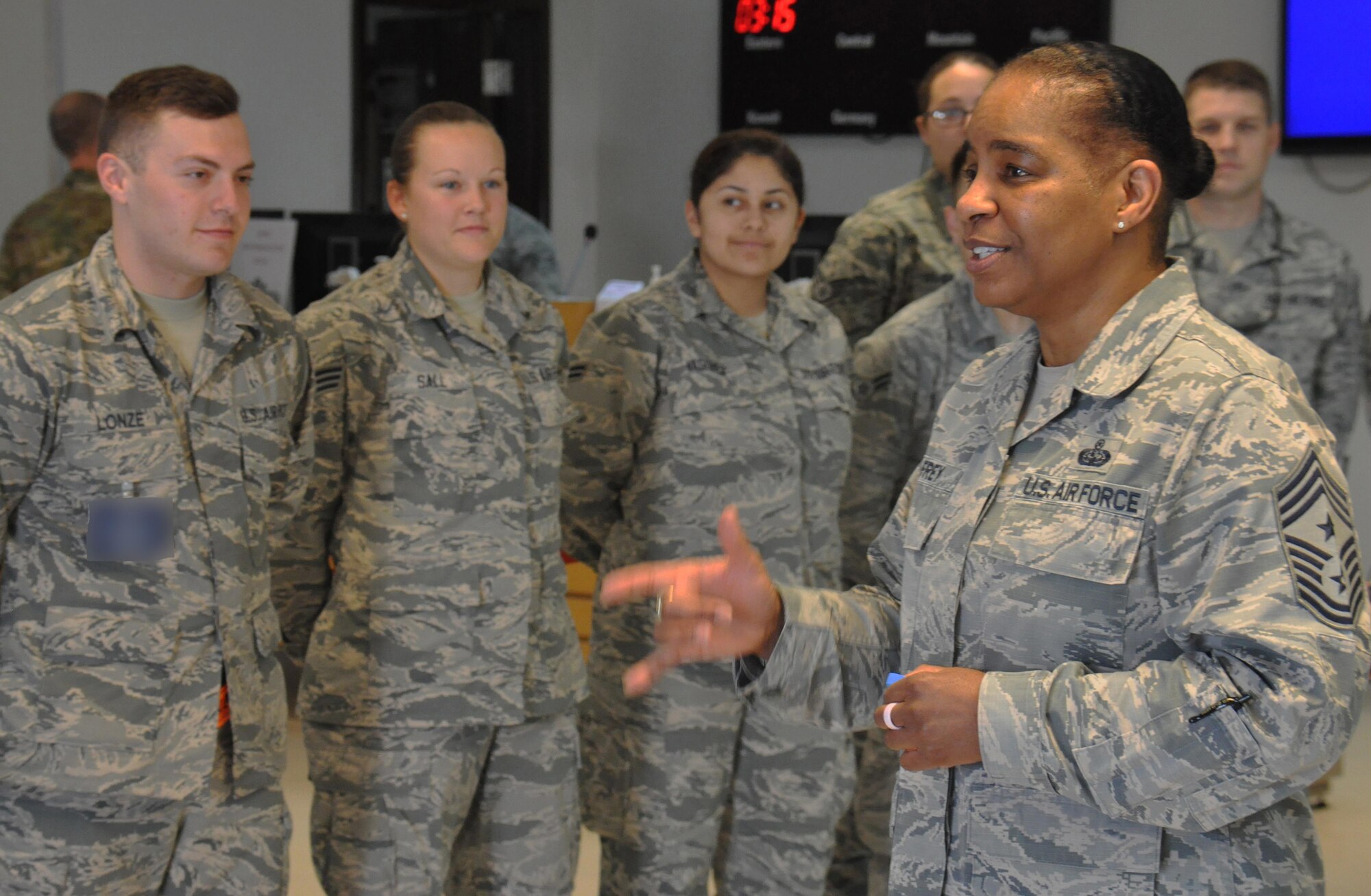 Chief Master Sgt. Shelina Frey, Air Mobility Command command chief, thanks members of the 8th Expeditionary Air Mobility Squadron for all they do to support the AMC mission during a visit to Al Udeid Air Base, Qatar March 11. Frey also took part in an all-call with AMC Commander Gen. Carlton Everhart II, March 13 where she stressed the importance of modernization and Airmen development. Photo altered for security purposes. (U.S. Air Force photo by Tech. Sgt. James Hodgman/Released)