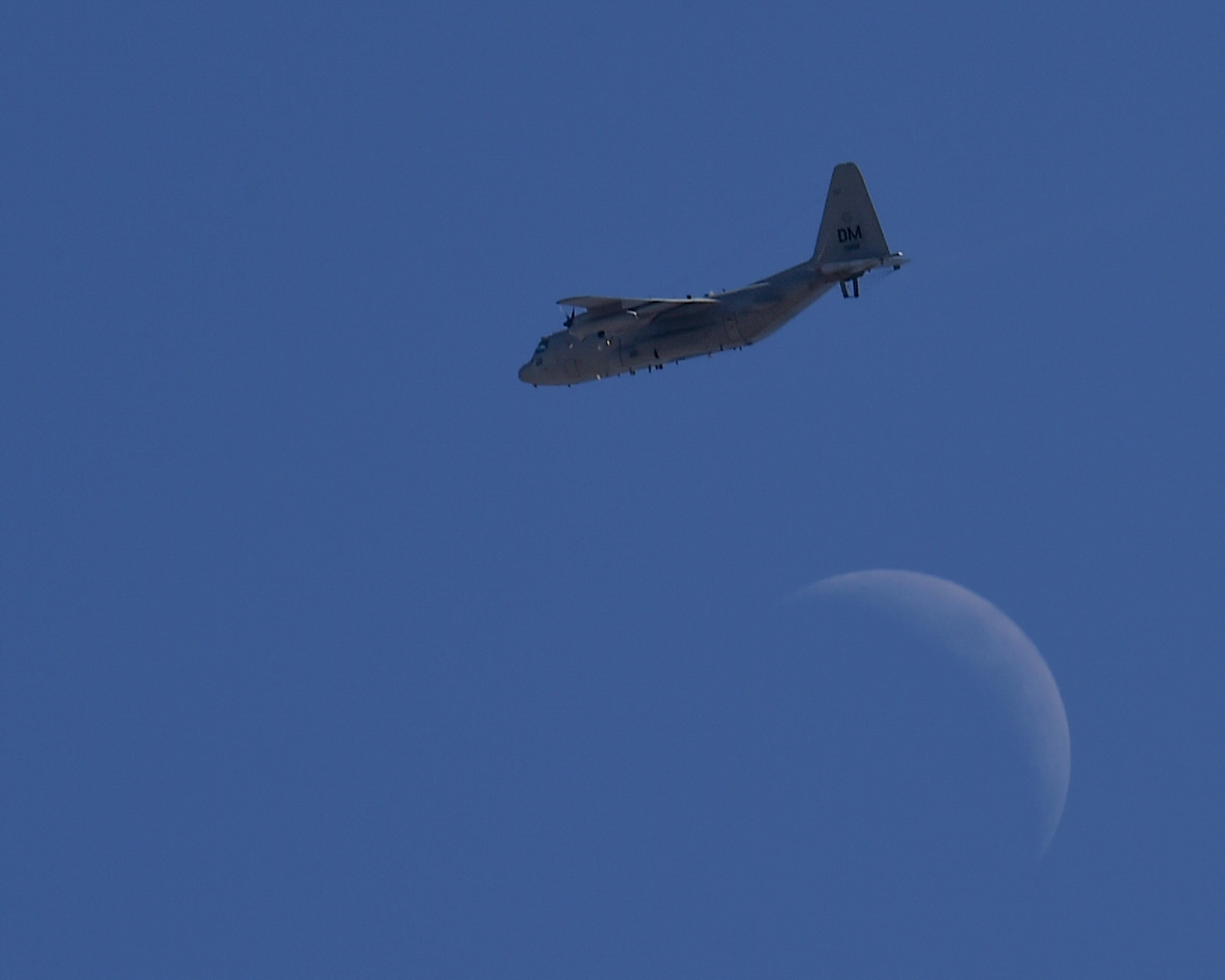 A U.S. Air Force EC-130H Compass Call flies over a crescent moon during the Thunder and Lightning over Arizona Open House at Davis-Monthan Air Force Base, Ariz., March 12, 2016. Arizona Open House at Davis-Monthan Air Force Base, Ariz., March 12, 2016. The base opened its doors for the free event to showcase military air power and express appreciation for the local community's continuous support of D-M's missions. (U.S. Air Force photo by Senior Airman Chris Massey/Released)
