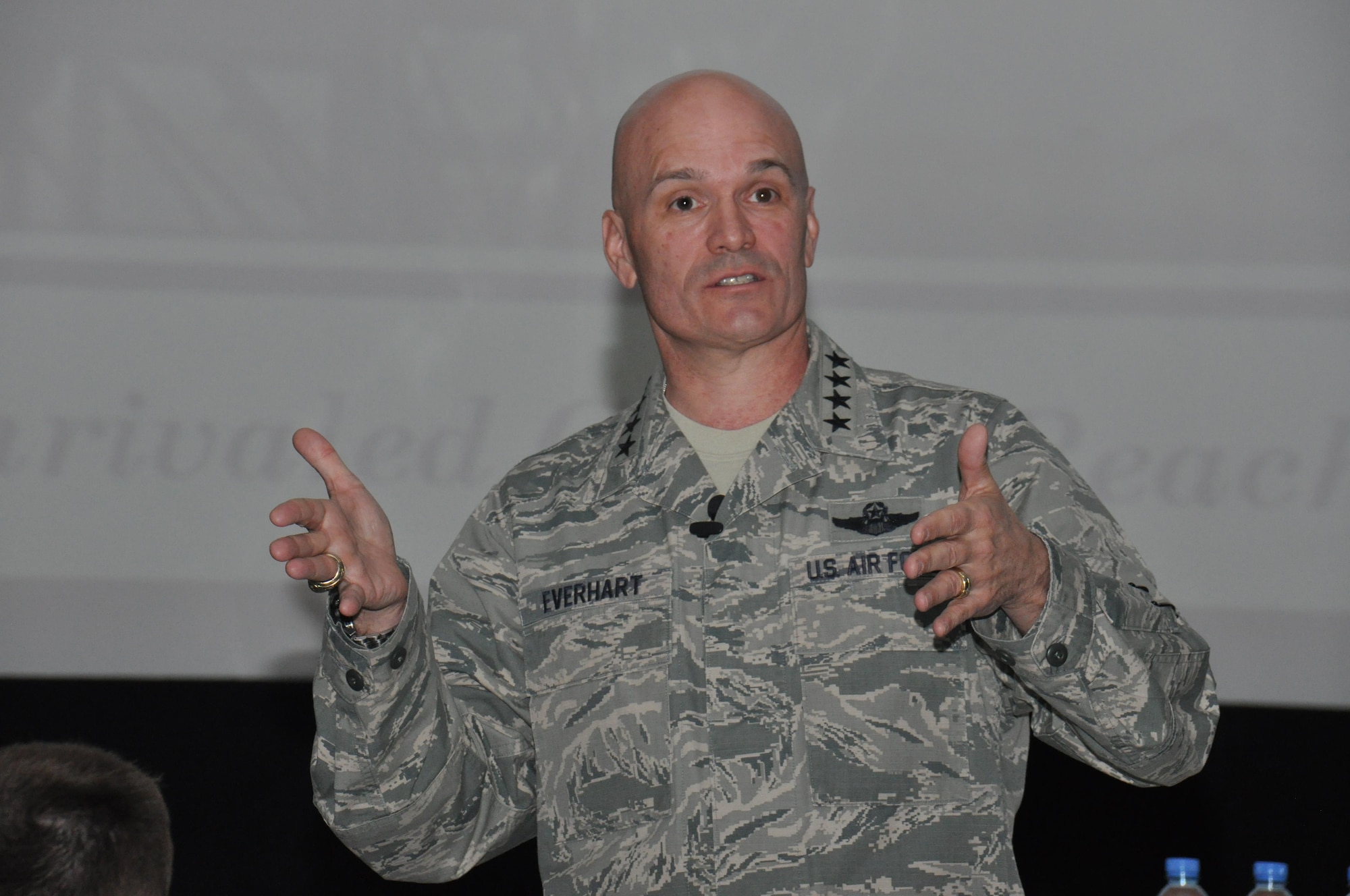 Gen. Carlton Everhart II, Air Mobility Command commander, addresses more than 500 Airmen during an all-call at Al Udeid Air Base, Qatar March 13. During the event, Everhart stressed the importance of maintaining readiness and modernizing mobility forces to face future challenges. He also thanked every Airman in attendance for his or her contribution to the AMC mission. (U.S. Air Force photo by Tech. Sgt. James Hodgman/Released)