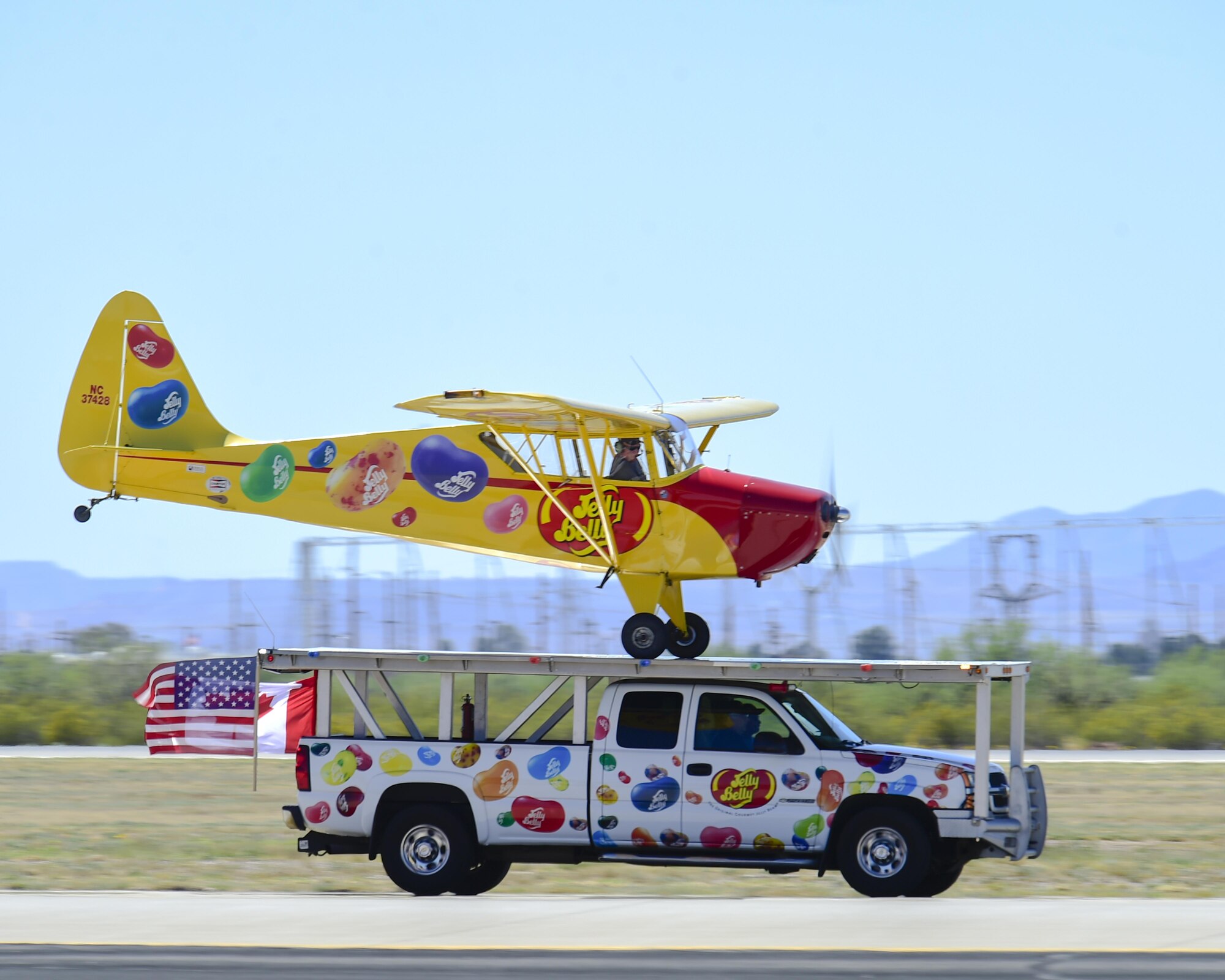 Kent Pietsch and the Jelly Belly airplane land on a moving Jelly Belly truck during the Thunder and Lightning over Arizona Open House at Davis-Monthan Air Force Base, Ariz., March 13, 2016. Pietsch flies the 800-pound Interstate Cadet airplane which has a 37-foot wingspan. (U.S. Air Force photo by Senior Airman Chris Massey/Released)