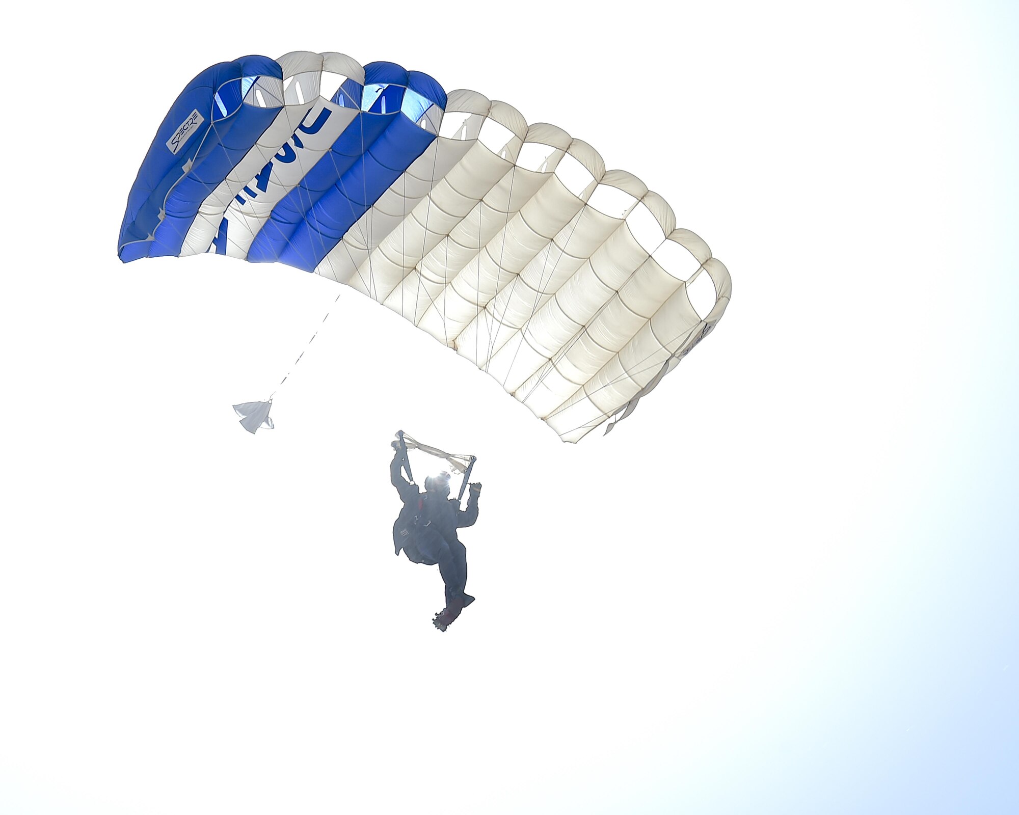 A member of the 98th Flying Training Squadron Wings of Blue skydiving demonstration team descends toward show center of the Thunder and Lightning over Arizona Open House at Davis-Monthan Air Force Base, Ariz., March 13, 2016.  Members of the team serve primarily as jumpmasters and instructors, devoting most of their time to teaching students about parachuting and training them to make unassisted freefall skydives. (U.S. Air Force photo by Senior Airman Chris Massey/Released)
