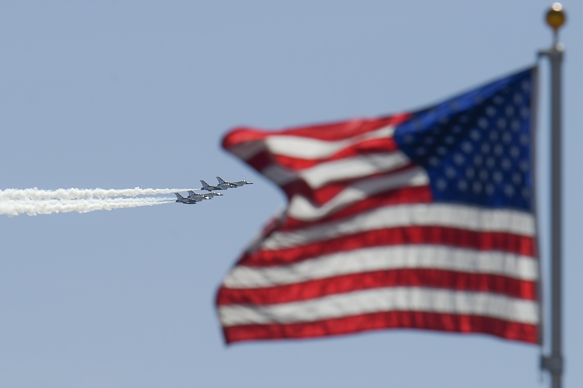 U.S. Air Force Air Demonstration Squadron, the Thunderbirds, perform a “Diamond Pass in Review” maneuver during the Thunder and Lightning over Arizona Open House event at Davis-Monthan Air Force Base, Ariz., March 13, 2016. The hour-long demonstration gave spectators the chance to witness the precise maneuvers and capabilities exhibited by these F-16 Fighting Falcon pilots. (U.S. Air Force photo by Senior Airman Chris Massey/Released)