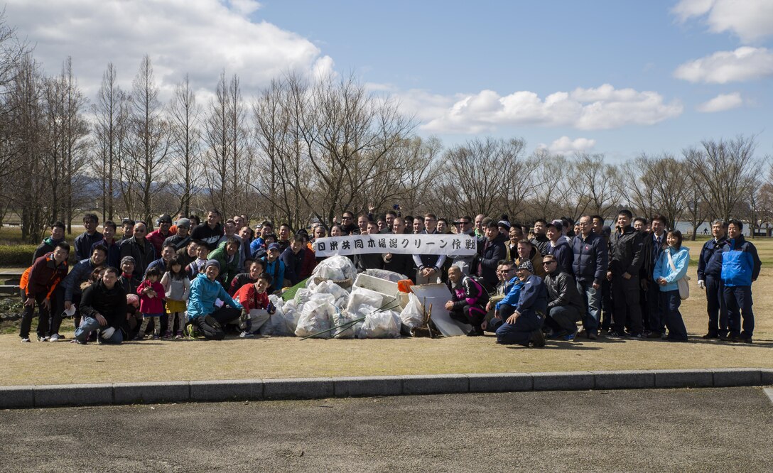 Members of Marine Fighter Attack Squadron (VMFA) 314, forward based at Marine Corps Air Station Iwakuni, Japan; Marine Aviation Logistics Squadron 12; Marine Aircraft Group 12 and Japan Air Self-Defense Force pose for a picture with a banner that states U.S. - Japan Operation Kibagata, after successfully cleaning Kibagata Park in Komatsu, Japan, March 12, 2016. The Marines and JASDF are all participating in the Komatsu Aviation Training Relocation exercise at Komatsu Air Base.  This community relations event brought approximately 90 service members together to clean up the local park. (U.S. Marine Corps photo by Cpl. Nicole Zurbrugg/Released)