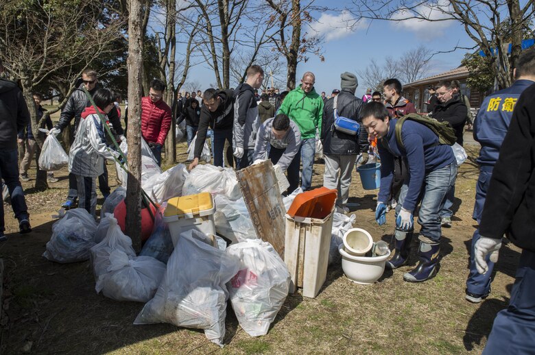 Members of Marine Fighter Attack Squadron (VMFA) 314, forward based at Marine Corps Air Station Iwakuni, Japan; Marine Aviation Logistics Squadron 12; Marine Aircraft Group 12 and Japan Air Self-Defense Force pile all the trash gathered during Operation Kibagata at Kibagata Park, Komatsu, Japan, March 12, 2016. Operation Kibagata brought participants of the Komatsu Aviation Training Relocation exercise at Komatsu Air Base together to clean the local community. Community relations events not only lend a hand to the local community, they are an important aspect of strengthening one of the world’s strongest alliances in order to maintain peace and stability in the region. (U.S. Marine Corps photo by Cpl. Nicole Zurbrugg/Released)