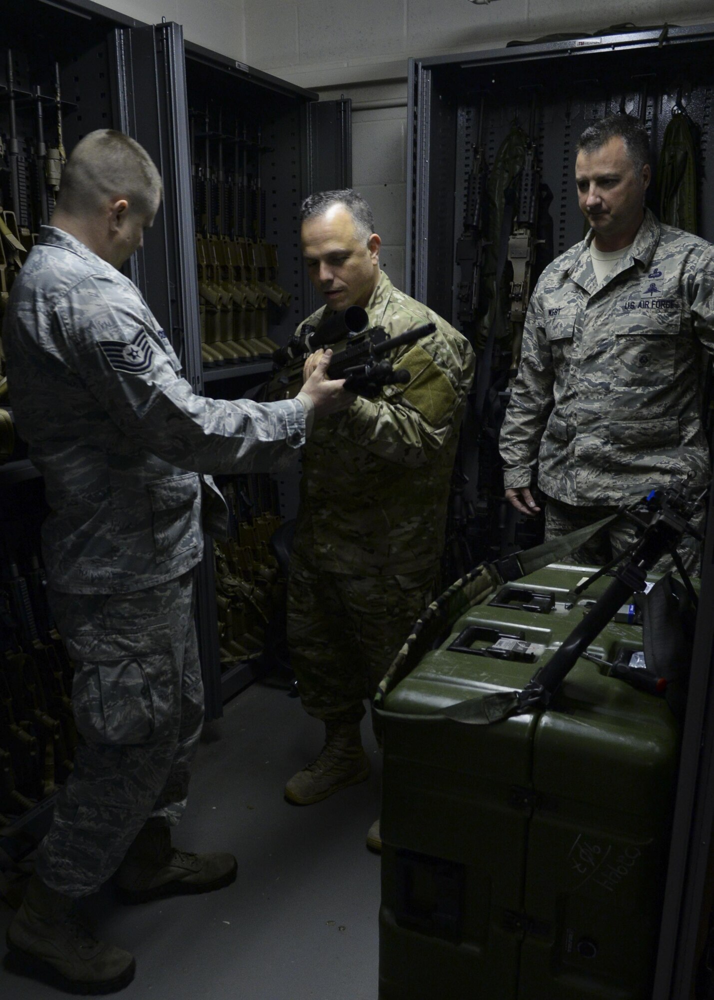 U.S. Air Force Chief Master Sgt. Matthew M. Caruso, middle, command chief, Air Force Special Operations Command, speaks to Tech Sgt. Keith Corcoran, left, 321st Special Tactics Squadron Combat Arms Training and Maintenance NCO-in charge, and Chief Master Sgt. Michael West, right, 321st STS chief enlisted manager, while on a base tour March 14, 2016, on RAF Mildenhall, England.  Caruso made stops at multiple units within the 352nd SOW in order to meet, greet and recognize outstanding Airmen. (U.S. Air Force photo by Senior Airman Victoria H. Taylor/Released)
