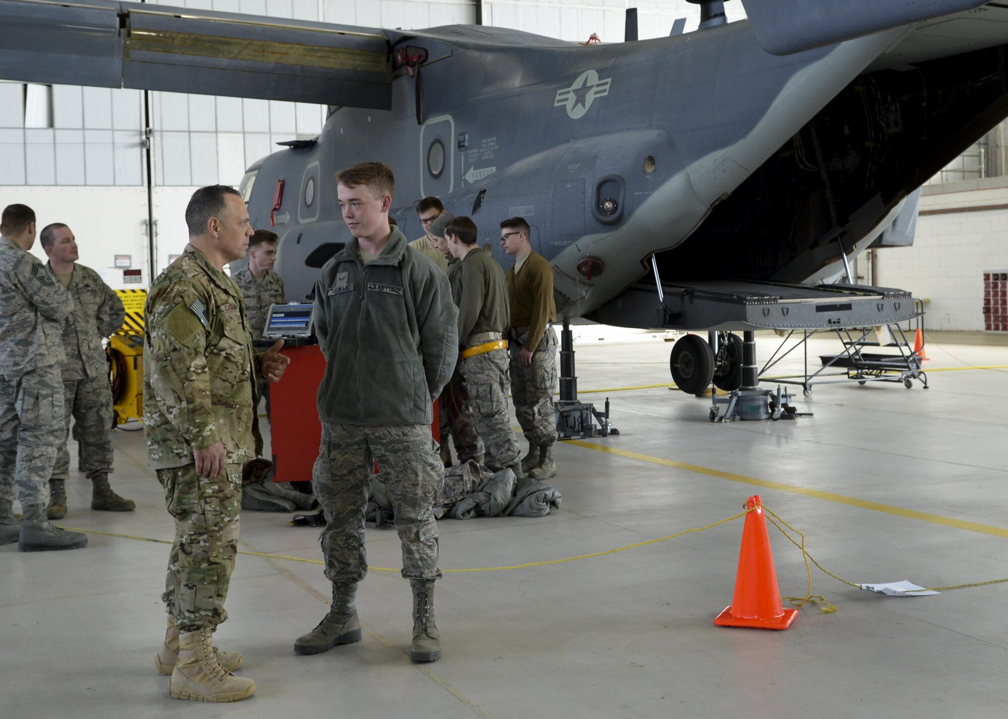 U.S. Air Force Chief Master Sgt. Matthew M. Caruso, left, command chief, Air Force Special Operations Command, speaks with Airman 1st Class Jonathan Howard, 352nd Special Operations Maintenance Squadron CV-22 Osprey tilt rotor mechanic, while on a base tour March 14, 2016, on RAF Mildenhall, England. Caruso spent much of his time talking to Airmen from different shops about their various accomplishments and the important role they play in the AFSOC mission. (U.S. Air Force photo by Senior Airman Victoria H. Taylor/Released)