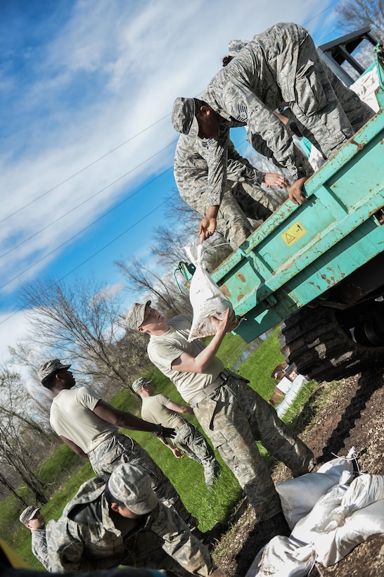 Airmen unload sandbags in Bossier City, La., March 10, 2016. The additional manpower decreased the time needed to create defensive barriers, reducing the chances of damage to the Red Chute Bayou levee. Air Force photo by Senior Airman Mozer O. Da Cunha