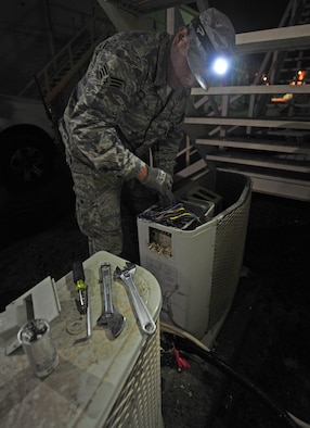 Senior Airman Jeremy, a heating, ventilation and air-conditioning technician assigned to the 380th Expeditionary Civil Engineering Squadron, makes night time repairs to a dormitory air conditioning unit at undisclosed location in Southwest Asia, March 2, 2016. Currently, HVAC technicians responds to about 500 to 600 work orders a month, but that number is expected to increase to 900 during the heat of the summer. The HVAC unit here is broken down into three shifts, allowing them to respond and perform maintenance request 24/7. (U.S. Air Force photo by Staff Sgt. Kentavist P. Brackin/released)
