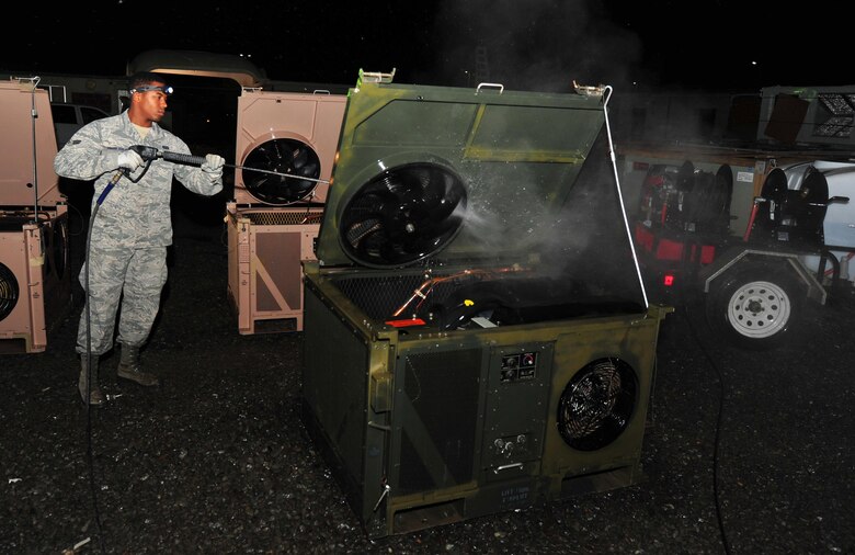 Airman 1st Class Britain, heating, ventilation and air conditioning technician assigned to the 380th Expeditionary Civil Engineering Squadron, sprays and cleans an airconditioning-system at an undisclosed location in Southwest Asia, March 2, 2016. There are nearly 4,000 air conditioning systems here and HVACs’ section of 31 Airmen is responsible for maintainining them all, including server and equipment rooms. (U.S. Air Force photo by Staff Sgt. Kentavist P. Brackin/released)