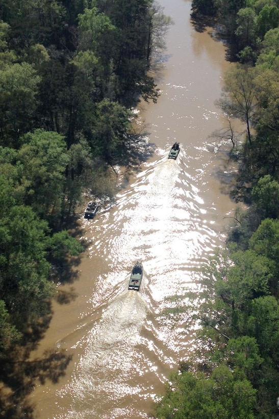 Soldiers travel in boats to reach residents stuck in their homes near Ponchatoula, La., March 13, 2016. The soldiers are assigned to the Louisiana National Guard's 2225th Multi-Role Bridge Company, 205th Engineer Battalion. Louisiana National Guard photo by Col. Rodney Painting