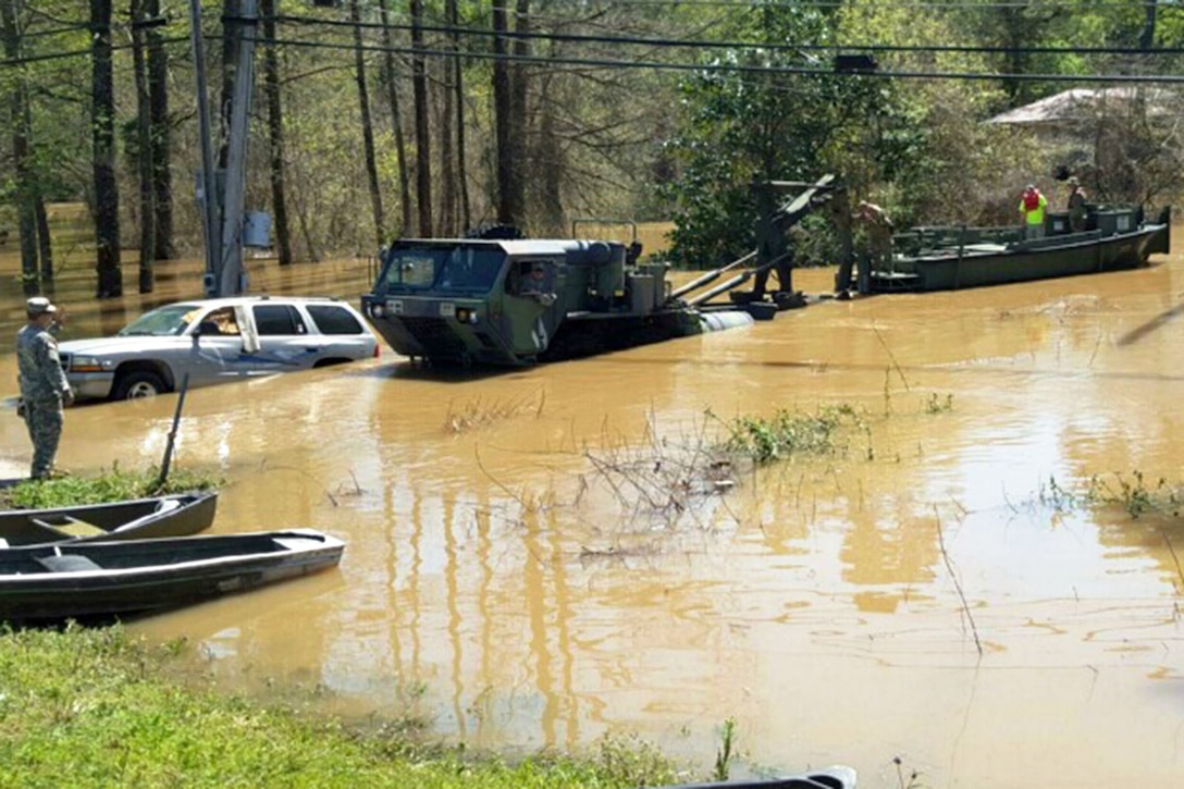 Soldiers launch a boat into the Tangipahoa River to go door to door to check on residents that could not get out of their homes just outside of Ponchatoula, La., March 13, 2016. The soldiers are assigned to the Louisiana National Guard's 2225th Multi-Role Bridge Company, 205th Engineer Battalion. Louisiana National Guard photo by Col. Rodney Painting