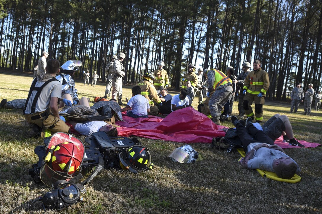 Team Seymour emergency responders tend to simulated victims during a mass casualty exercise, March 9, 2016, at Seymour Johnson Air Force Base, North Carolina. More than 40 Airmen simulated being dead or injured from a suicide bomber during the exercise. (U.S. Air Force photo/Airman Shawna L. Keyes)