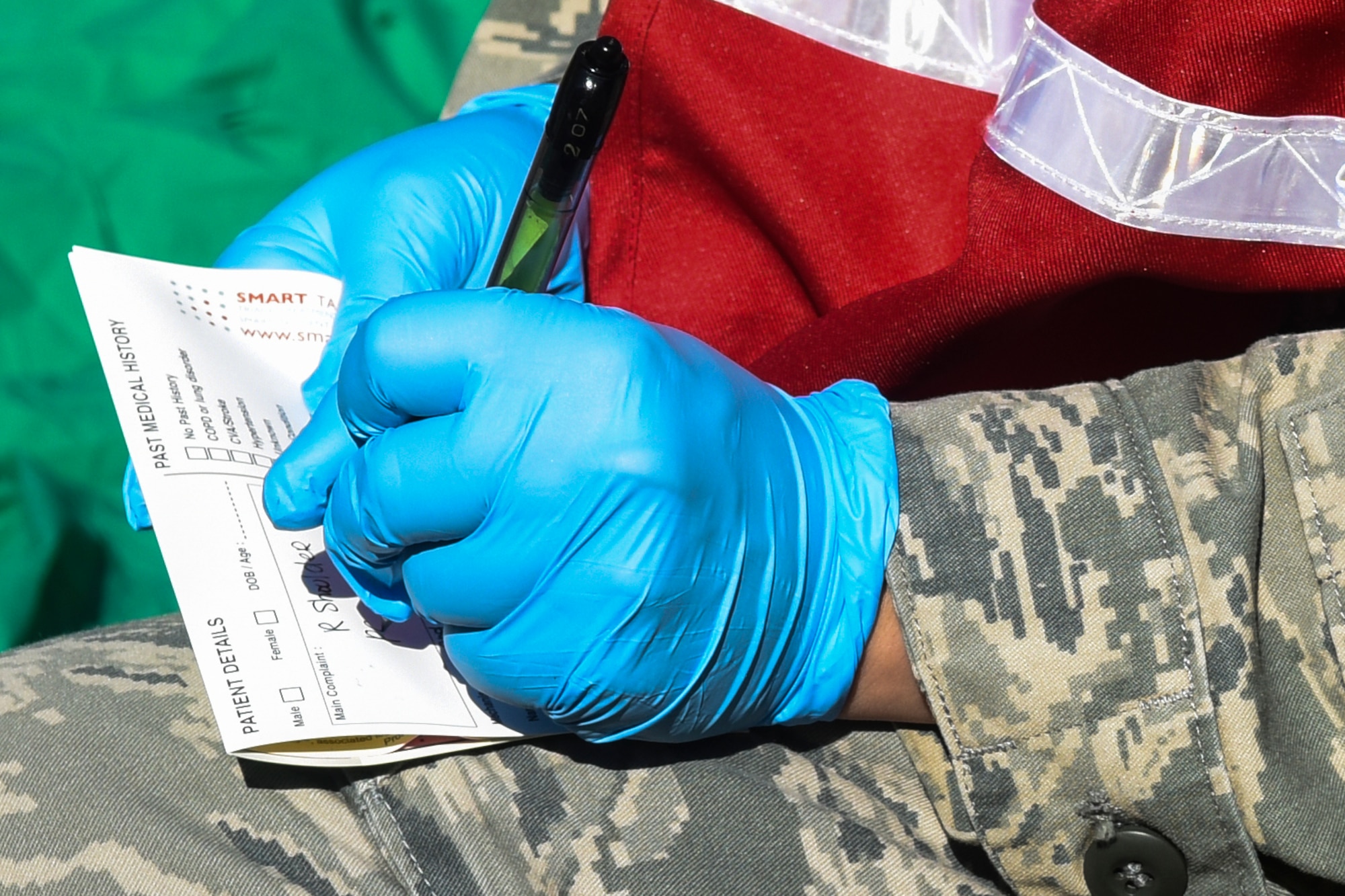 Senior Airman Gabrielle Terramiggi, 4th Medical Operations Squadron medical technician, annotates patient injuries, March 9, 2016, at Seymour Johnson Air Force Base, North Carolina. Airmen from the 4th MDOS triaged patients during a mass casualty exercise that tested medical and emergency personnel. (U.S. Air Force photo/Airman Shawna L. Keyes)