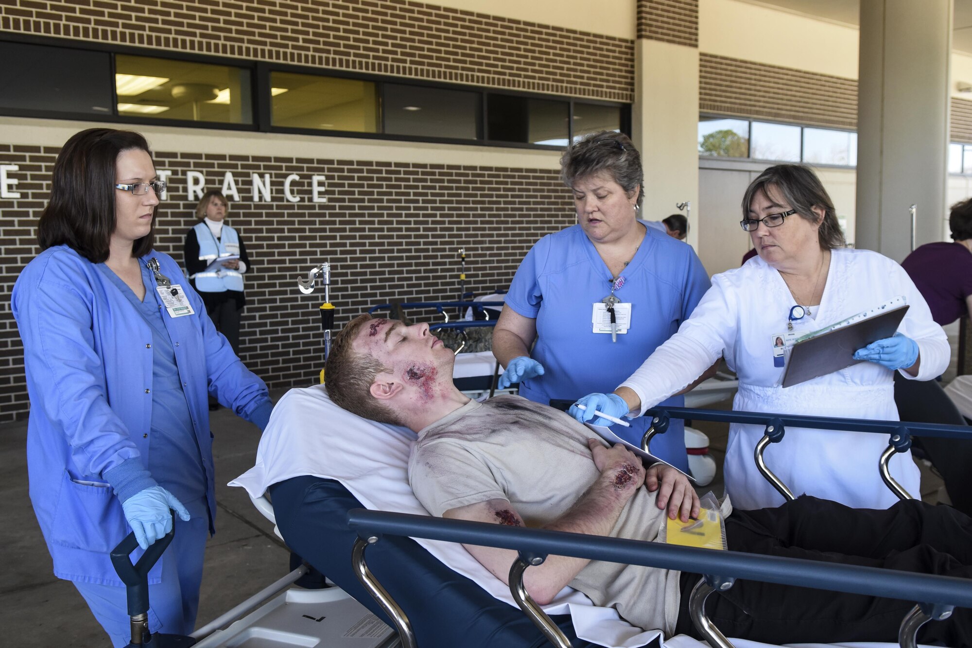 Medical Staff from Wayne Memorial Hospital admit an Airman with simulated injuries from a mass casualty exercise, March 9, 2016, in Goldsboro, North Carolina. The exercise tested base and community emergency response procedures. (U.S. Air Force photo/Airman Shawna L. Keyes)