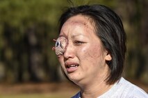 Senior Airman Sheng Morris, 4th Contracting Squadron contract specialist, cries out during a mass casualty exercise due to a simulated eye injury, March 9, 2016, at Seymour Johnson Air Force Base, North Carolina. Approximately 40 members of Team Seymour sustained simulated injuries from an explosive device during the exercise. (U.S. Air Force photo/Airman Shawna L. Keyes) 