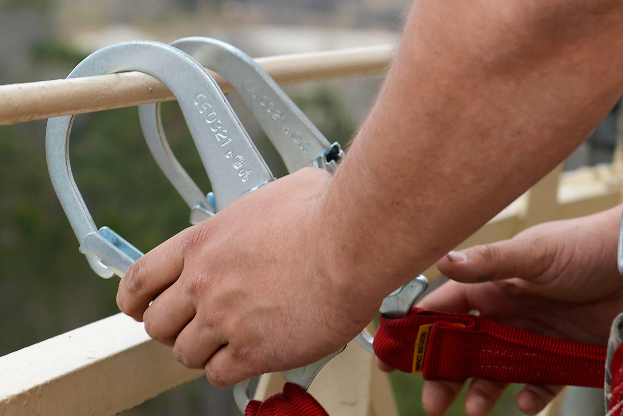 U.S. Air Force Staff Sgt. Ryan Schmutzler, 20th Civil Engineer Squadron water and fuels systems craftsman, hooks onto a beam on a base water tower at Shaw Air Force Base, S.C., March 1, 2016. As a safety precaution any Team Shaw member scaling a water tower must be given a proper safety briefing and utilize a safety harness before ascending. (U.S. Air Force photo by Airman 1st Class Christopher Maldonado)