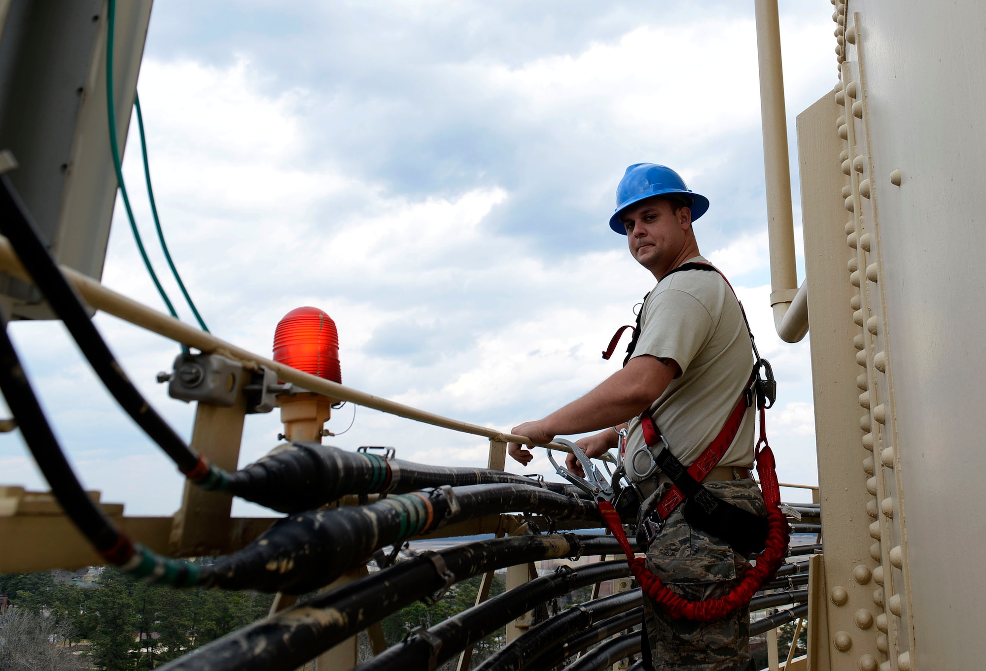 U.S. Air Force Staff Sgt. Ryan Schmutzler, 20th Civil Engineer Squadron water and fuels systems craftsman, checks wiring on a base water tower at Shaw Air Force Base, S.C., March 1, 2016. Airmen assigned to the 20th CES water and fuels systems shop scale the tower to check for corrosion, cracks, and leaks that may have occurred over time. (U.S. Air Force photo by Airman 1st Class Christopher Maldonado)