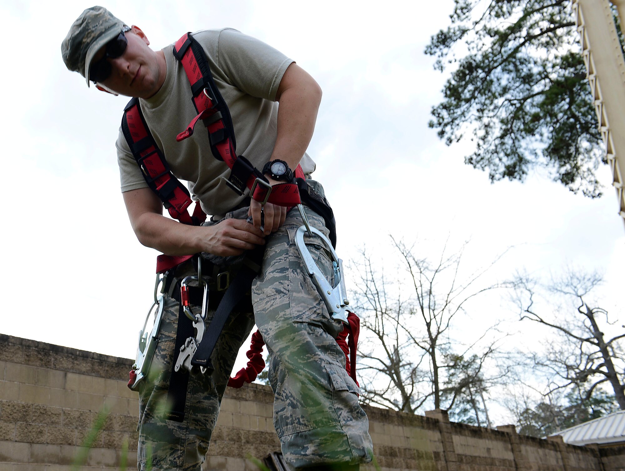 U.S. Air Force Staff Sgt. James Frye, 20th Civil Engineer Squadron water and fuels systems craftsman, prepares to scale a base water tower at Shaw Air Force Base, S.C., March 1, 2016. Before ascending the water tower, Airmen are given instructions on how to properly utilize their harness and what procedures to execute in an emergency situation. (U.S. Air Force photo by Airman 1st Class Christopher Maldonado) 