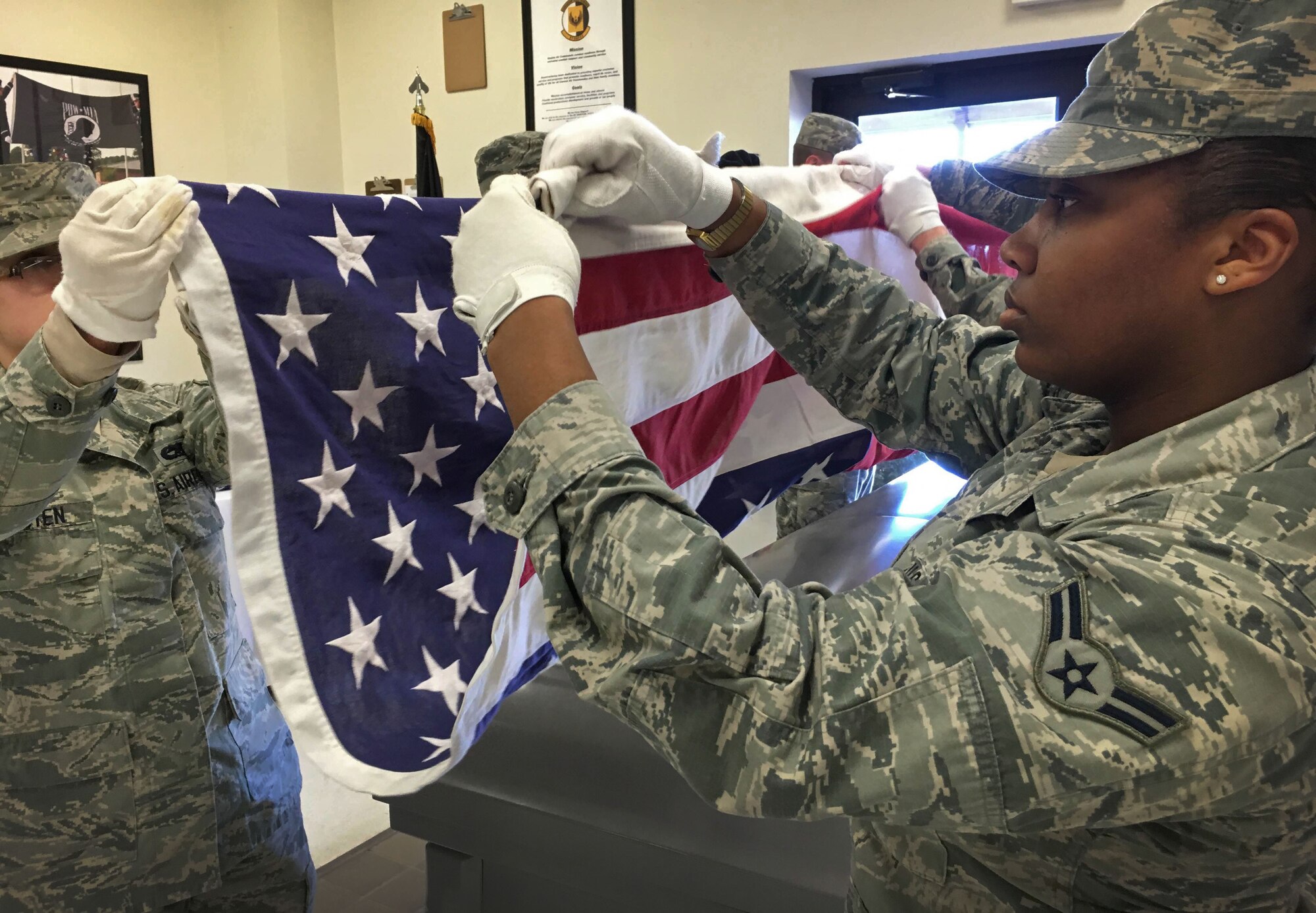 U.S. Air Force base honor guardsmen practice flag folding Jan. 28, 2016, at Cannon Air Force Base, N.M. Two-week training at Cannon also includes rifle movements, color ceremony procedures, flag carrying and folding along with other necessary techniques before being evaluated and qualified. (U.S. Air Force photo/Staff Sgt. Alexx Pons) 