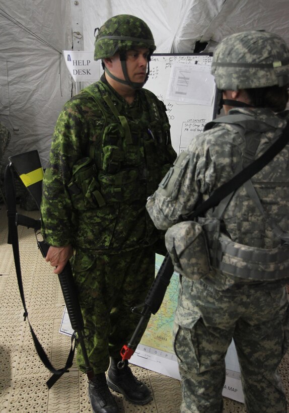 Canadian Army Reserve Capt. Rob Lelieure of the 36th Service Battalion, Halifax, Novia Scotia, shares a conversation with an Army Reserve soldier from the 77th Sustainment Brigade, 316th Sustainment Command (Expeditionary), 377th Theater Support Command, during the 84th Training Command’s first Combat Support Training Exercise 78-16-01 on Fort Knox, Ky., March 9, 2016. Lelieure was assuming the role as a liaison officer for his brigade in the exercise which was hosted by the 78th Training Division, Joint Base McGuire-Dix-Lakehurst, N.J. Several members of the battalion were serving in integral roles with the brigade. (U.S. Army Photo by Clinton Wood/Released)