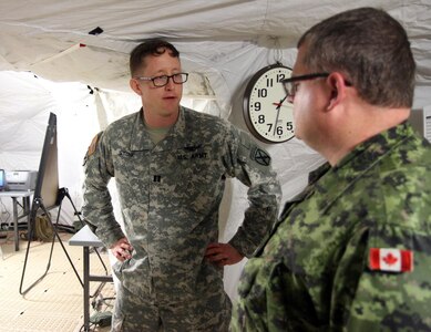 U.S. Army Capt. Matthew Stone, 10th Sustainment Brigade, 10th Mountain Division, Fort Drum, N.Y., shares a conversation with Canadian Army Reserve Lt. Col. Randy Spaulding of the 36th Service Battalion, Halifax, Novia Scotia, during the 84th Training Command’s first Combat Support Training Exercise 78-16-01 on Fort Knox, Ky., March 9, 2016. The brigade is regionally aligned with the 77th Sustainment Brigade, 316th Sustainment Command (Expeditionary), 377th Theater Support Command, during the 21-day exercise which is hosted by the 78th Training Division, Joint Base McGuire-Dix-Lakehurst, N.J. (U.S. Army Photo by Clinton Wood/Released)