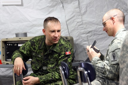 Canadian Army Reserve Master Warrant Officer Marc Lavoie, 36th Service Battalion, Halifax, Novia Scotia, explains to U.S. Army Reserve Sgt. 1st Class Mark Keevan, 77th Sustainment Brigade, 316th Sustainment Command (Expeditionary), 377th Theater Support Command, how the speed loader for the Canadian C7A2 Rifle will work in the American M16A2 rifle during the 84th Training Command’s first Combat Support Training Exercise 78-16-01 on Fort Knox, Ky., March 9, 2016. Lavoie and a few of his fellow soldiers were serving in integral roles with the brigade in the exercise which was hosted by the 78th Training Division, Joint Base McGuire-Dix-Lakehurst, N.J. (U.S. Army Photo by Clinton Wood/Released)