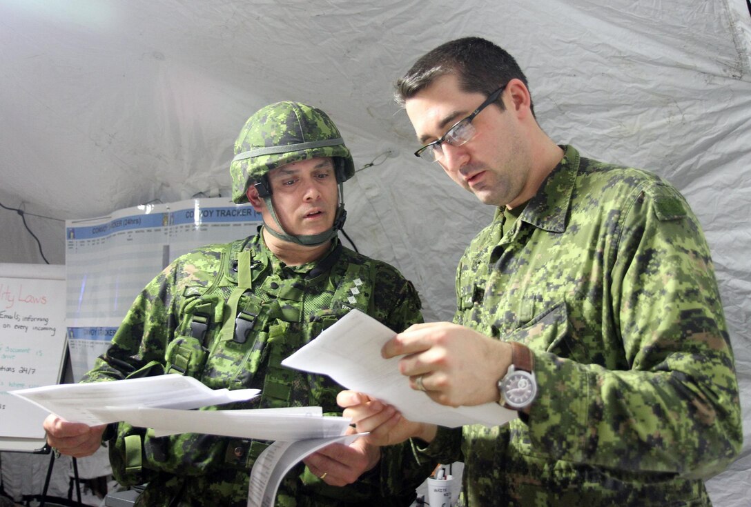 Canadian Army Reserve Capt. Rob Lelieure, left, discusses an issue with Capt. Patrick Lahey, both who are with the 36th Service Battalion, Halifax, Novia Scotia, during the 84th Training Command’s first Combat Support Training Exercise 78-16-01 on Fort Knox, Ky., March 9, 2016. Lelieure was assuming the role as a liaison officer for his battalion in the exercise which was hosted by the 78th Training Division, Joint Base McGuire-Dix-Lakehurst, N.J. Several members of the battalion were serving in integral roles with the brigade. (U.S. Army Photo by Clinton Wood/Released)