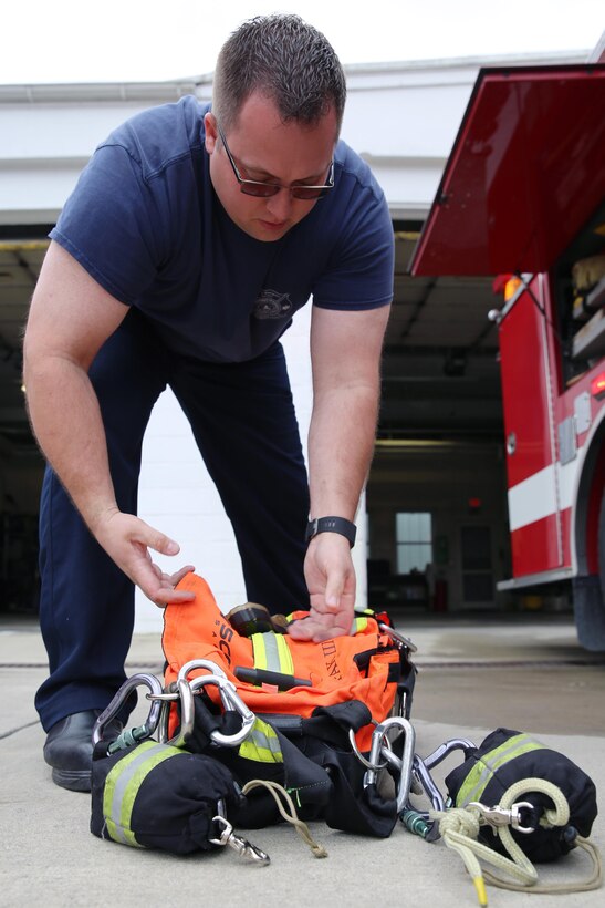 Dustin J. Schneider conducts a routine check of fire and safety gear at Marine Corps Air Station Cherry Point, N.C. Schneider earned the Marine Corps Civilian Firefighter of the Year Award for excellence in his job performance. Schneider was chosen from firefighters in fire departments across the Marine Corps. Schneider serves with Cherry Point Fire and Emergency Services. (U.S. Marine Corps photo by Lance Cpl. Mackenzie Gibson/Released)
