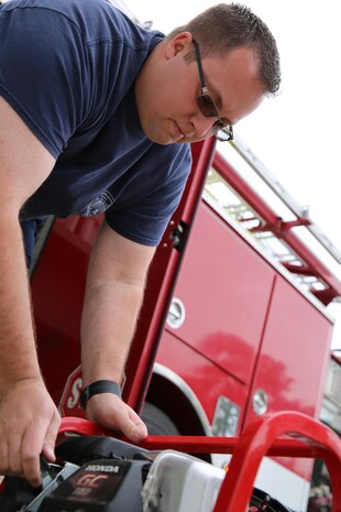 Dustin J. Schneider conducts a routine check of fire and safety gear at Marine Corps Air Station Cherry Point, N.C. Schneider earned the Marine Corps Civilian Firefighter of the Year Award for excellence in his job performance. Schneider was chosen from firefighters in fire departments across the Marine Corps. Schneider serves with Cherry Point Fire and Emergency Services. (U.S. Marine Corps photo by Lance Cpl. Mackenzie Gibson/Released)