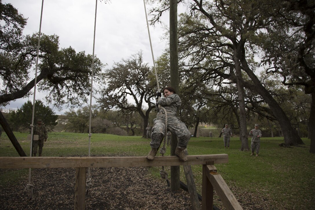 U.S. Army Sgt. Marcy DiOssi assigned to the 102nd Training Division of Ft. Leonard Wood, Mo., navigates the Swing and Jump obstacle at the Obstacle Course event during the 80th Training Command 2016 Best Warrior Competition (BWC) in conjunction with the 99th Regional Support Command at Camp Bullis, Texas, March 11, 2016. The BWC is an annual competition to identify the strongest and most well-rounded Soldiers through the accomplishment of physical and mental challenges, as well as basic Soldier skills. (U.S. Army photo by Cpl. Cope Steven).