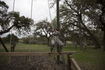 U.S. Army Sgt. Marcy DiOssi assigned to the 102nd Training Division of Ft. Leonard Wood, Mo., navigates the Swing and Jump obstacle at the Obstacle Course event during the 80th Training Command 2016 Best Warrior Competition (BWC) in conjunction with the 99th Regional Support Command at Camp Bullis, Texas, March 11, 2016. The BWC is an annual competition to identify the strongest and most well-rounded Soldiers through the accomplishment of physical and mental challenges, as well as basic Soldier skills. (U.S. Army photo by Cpl. Cope Steven).