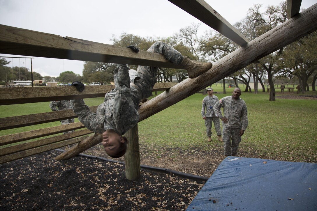 U.S. Army Sgt. Agnes Jibke assigned to the 7-80th TCBN of Ft. Eustis, Va., navigates the Weaver obstacle at the Obstacle Course event during the 80th Training Command 2016 Best Warrior Competition (BWC) in conjunction with the 99th Regional Support Command at Camp Bullis, Texas, March 11, 2016. The BWC is an annual competition to identify the strongest and most well-rounded Soldiers through the accomplishment of physical and mental challenges, as well as basic Soldier skills. (U.S. Army photo by Cpl. Cope Steven).