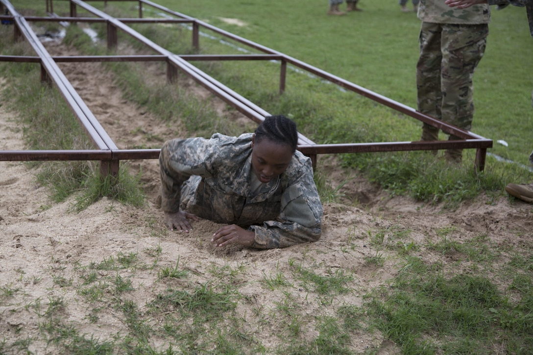 U.S. Army Spc. Yvonne Wiggins assigned to the 7th of the 95th Joint Reserve Base of Grand Prairie, Texas, navigates the Low Crawl obstacle at the Obstacle Course event during the 80th Training Command 2016 Best Warrior Competition (BWC) in conjunction with the 99th Regional Support Command at Camp Bullis, Texas, March 11, 2016. The BWC is an annual competition to identify the strongest and most well-rounded Soldiers through the accomplishment of physical and mental challenges, as well as basic Soldier skills. (U.S. Army photo by Cpl. Cope Steven).