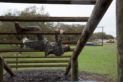 U.S. Army Spc. Connor Walraven assigned to the 319th Army Band of Ft. Totten, N.Y., navigates the Weaver obstacle at the Obstacle Course event during the 80th Training Command 2016 Best Warrior Competition (BWC) in conjunction with 99th Regional Support Command at Camp Bullis, Texas, March 11, 2016. The BWC is an annual competition to identify the strongest and most well-rounded Soldiers through the accomplishment of physical and mental challenges, as well as basic Soldier skills. (U.S. Army photo by Cpl. Cope Steven).