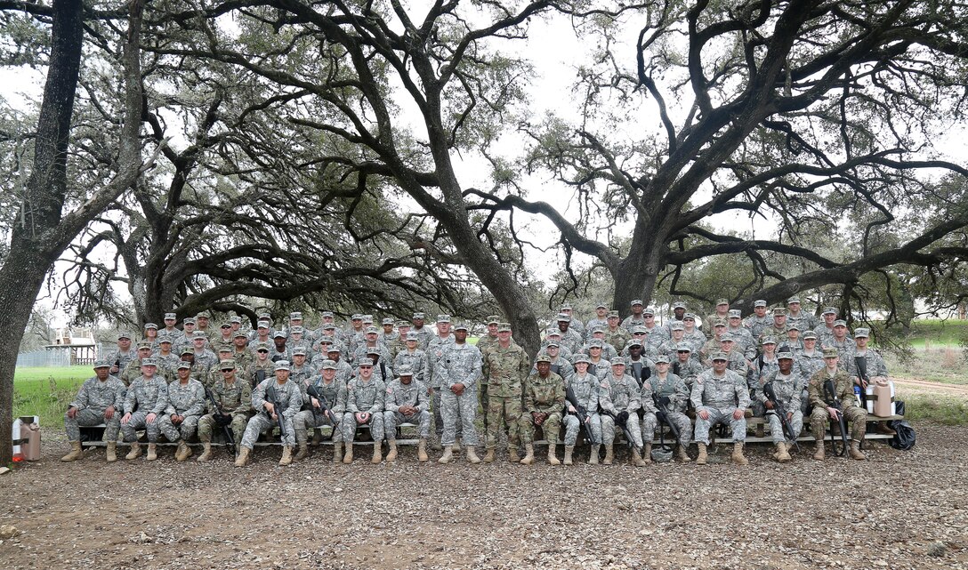 The Best Warrior competitors along with U.S. Army Command Sgt. Maj. Jeff Darlington (middle), assigned to 80th Training Command, poses for a group photo prior to Obstacle Course event during the 80th Training Command 2016 Best Warrior Competition (BWC) in conjunction with 99th Regional Support Command at Camp Bullis, Texas, March 11, 2016. The BWC is an annual competition to identify the strongest and most well-rounded Soldiers through the accomplishment of physical and mental challenges, as well as basic Soldier skills. (U.S. Army photo by Spc. Darnell Torres/Released).