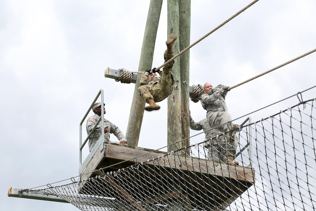 U.S. Army Command Sgt. Maj. Shahpour Eskandary (left) assigned to 5/80th Regiment Ordnance 3rd Brigade and Command Sgt. Maj. Jeff Darlington (right), assigned to 80th Training Command (right) demonstrate the Inverted Rope Decent Course during the 80th Training Command Best Warrior Competition (BWC) 2016 in conjunction with 99th Regional Support Command at Camp Bullis, Texas, March 11, 2016. The BWC is an annual competition to identify the strongest and most well-rounded Soldiers through the accomplishment of physical and mental challenges, as well as basic Soldier skills. (U.S. Army photo by Spc. Darnell Torres/Released).