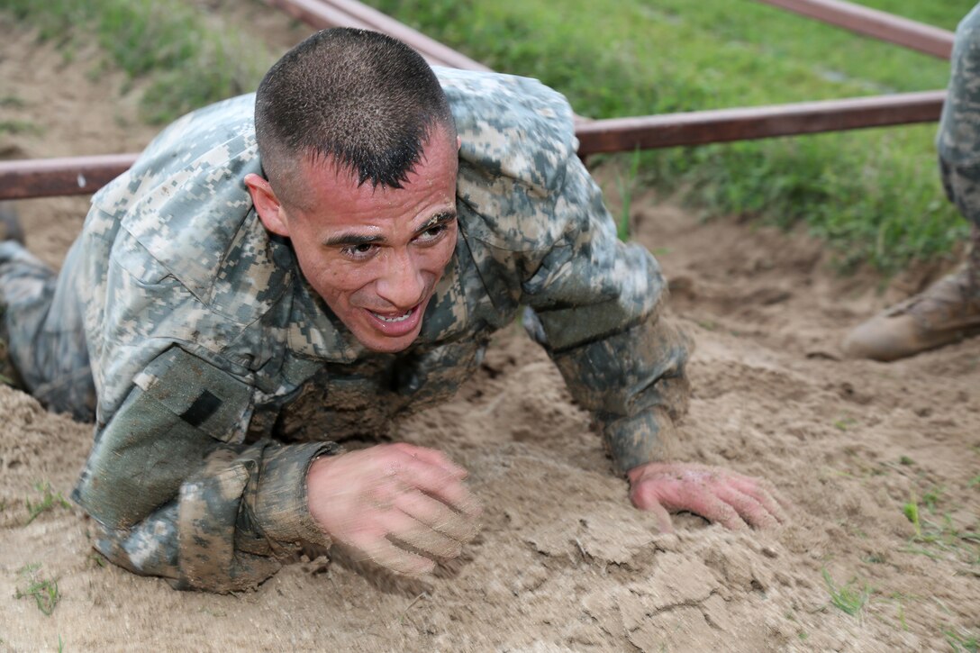U.S. Army Sgt. Daniel Bishop, assigned to 3/399th Battalion navigates the Low Crawl Pits Course during the 80th Training Command 2016 Best Warrior Competition (BWC) in conjunction with 99th Regional Support Command at Camp Bullis, Texas, March 11, 2016. The BWC is an annual competition to identify the strongest and most well-rounded Soldiers through the accomplishment of physical and mental challenges, as well as basic Soldier skills. (U.S. Army photo by Spc. Darnell Torres/Released).