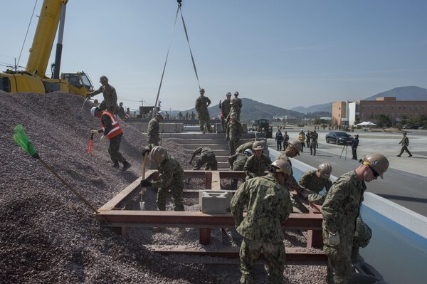 U.S. Navy and South Korean Seabees place concrete blocks, move aggregate, and conduct crane operations during pier repair training as part of exercise Foal Eagle 2016 in Jinhae, South Korea, March 15, 2016. Navy photo by Chief Lowell Whitman
