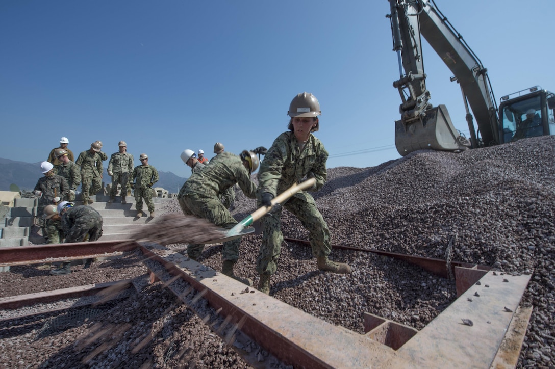 Navy Seaman Brooklyn Allen shovels aggregate with South Korea Seabees as they train to repair piers during exercise Foal Eagle 2016 in Jinhae, South Korea, March 15, 2016. The annual training exercise is designed to enhance the readiness of U.S. and South Korean forces, and their ability to work together during a crisis. U.S. Navy photo by Chief Lowell Whitman