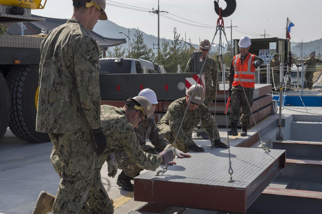 U.S. Navy and South Korean Seabees conduct crane operations during pier repair training as part of exercise Foal Eagle 2016 in Jinhae,  South Korea, March 15, 2016. Navy photo by Chief Lowell Whitman