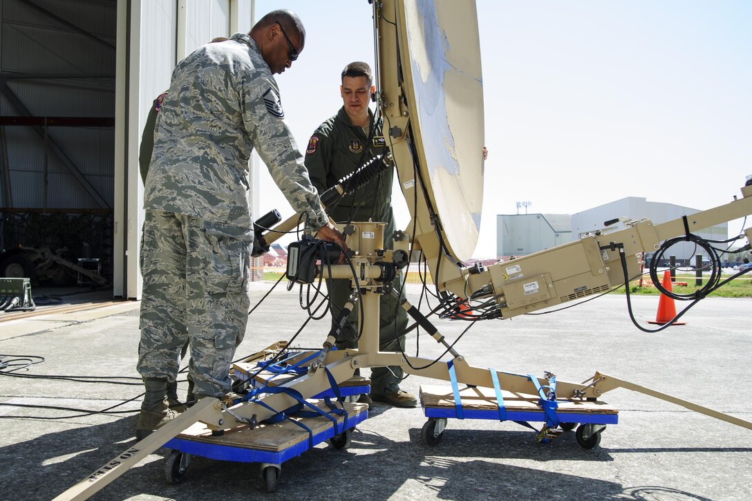 Lt. Col. Greg Schnurrenberger, Maj. Kevin Watry and Master Sgt. Eric Walker, all members of the 315th Airlift Control Flight, set up communications equipment during a Joint Base Charleston earthquake exercise March 15, 2016. Multiple entities participated in the exercise, which was conducted to maintain the Base’s readiness during times of natural disaster. (U.S. Air Force photo by Senior Airman Jonathan Lane/Released)