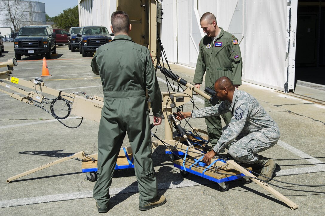 Lt. Col. Greg Schnurrenberger, Maj. Kevin Watry and Master Sgt. Eric Walker, all members of the 315th Airlift Control Flight, set up communications equipment during a Joint Base Charleston earthquake exercise March 15, 2016. Multiple entities participated in the exercise, which was conducted to maintain the Base’s readiness during times of natural disaster. (U.S. Air Force photo by Senior Airman Jonathan Lane/Released)