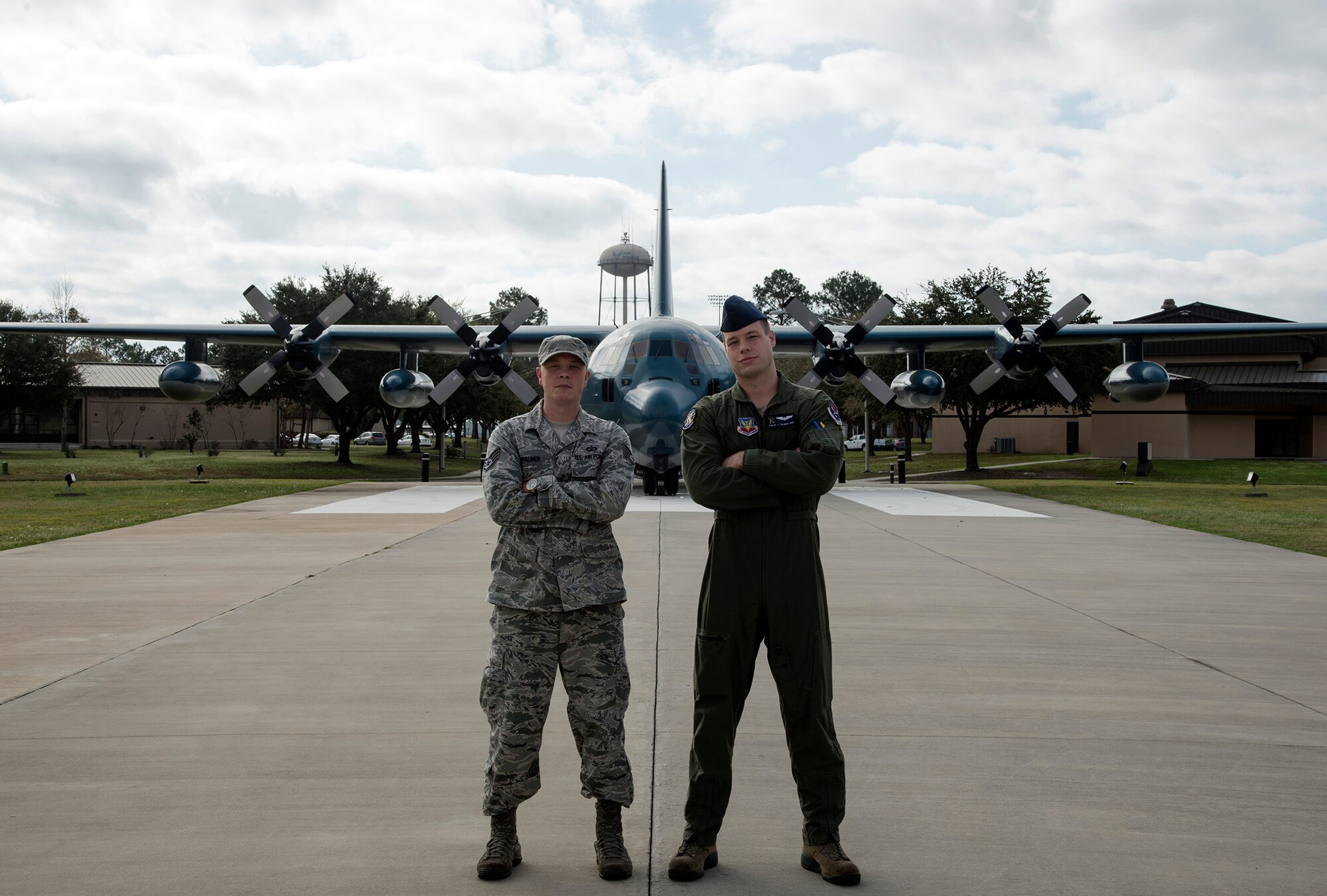 U.S. Air Force Staff Sgt. Adam Palmer, 23d Operations Support Squadron air traffic controller, left, poses for a photo with his younger brother Senior Airman Philip Palmer, 71st Rescue Squadron loadmaster, March 14, 2016, at Moody Air Force Base, Ga. The brothers have spent four years at Moody and were allowed the opportunity to fulfill their duties as Airmen, together. (U.S. Air Force Photo by Airman 1st Class Janiqua P. Robinson/Released)